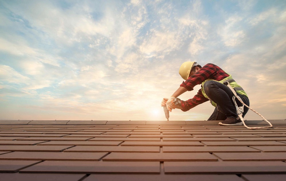 man installing new roof